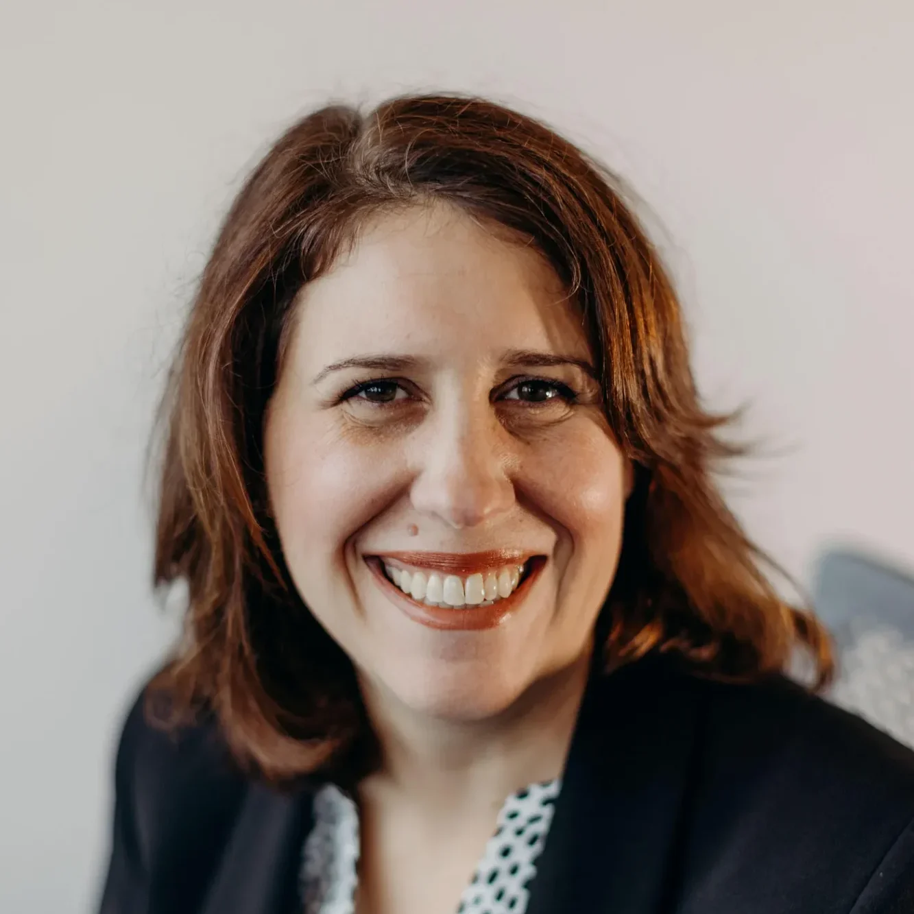 8THIRTYFOUR Lets Talk About Badass Women Alissa Roath smiles at the camera while sitting down