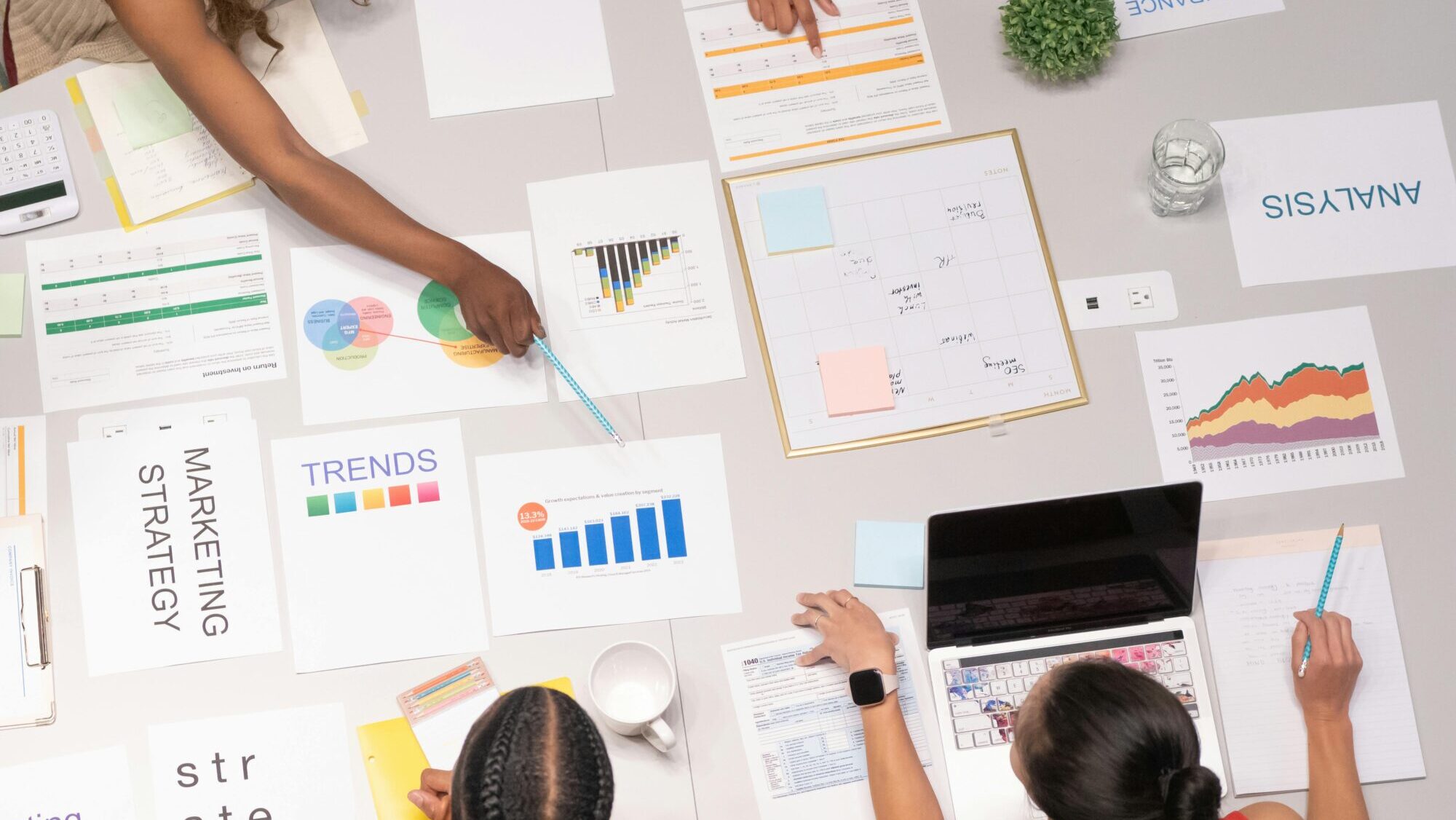 A group of people working at a desk on marketing strategies