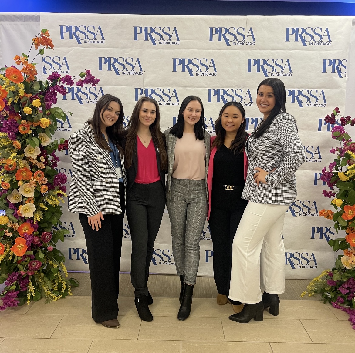 A group of women pose at a PRSSA event.