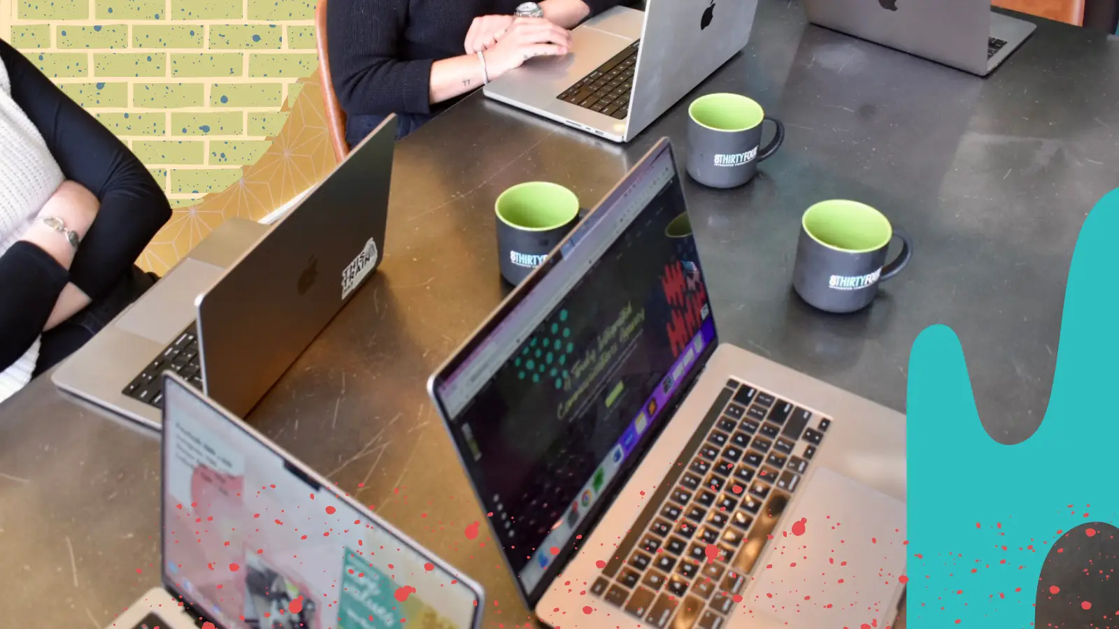 A group of people work together on their laptops at 8THIRTYFOUR.
