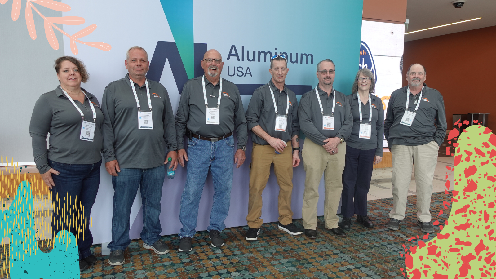 Team members of Empire Solutions stand infront of the event signage for a convention in Nashville