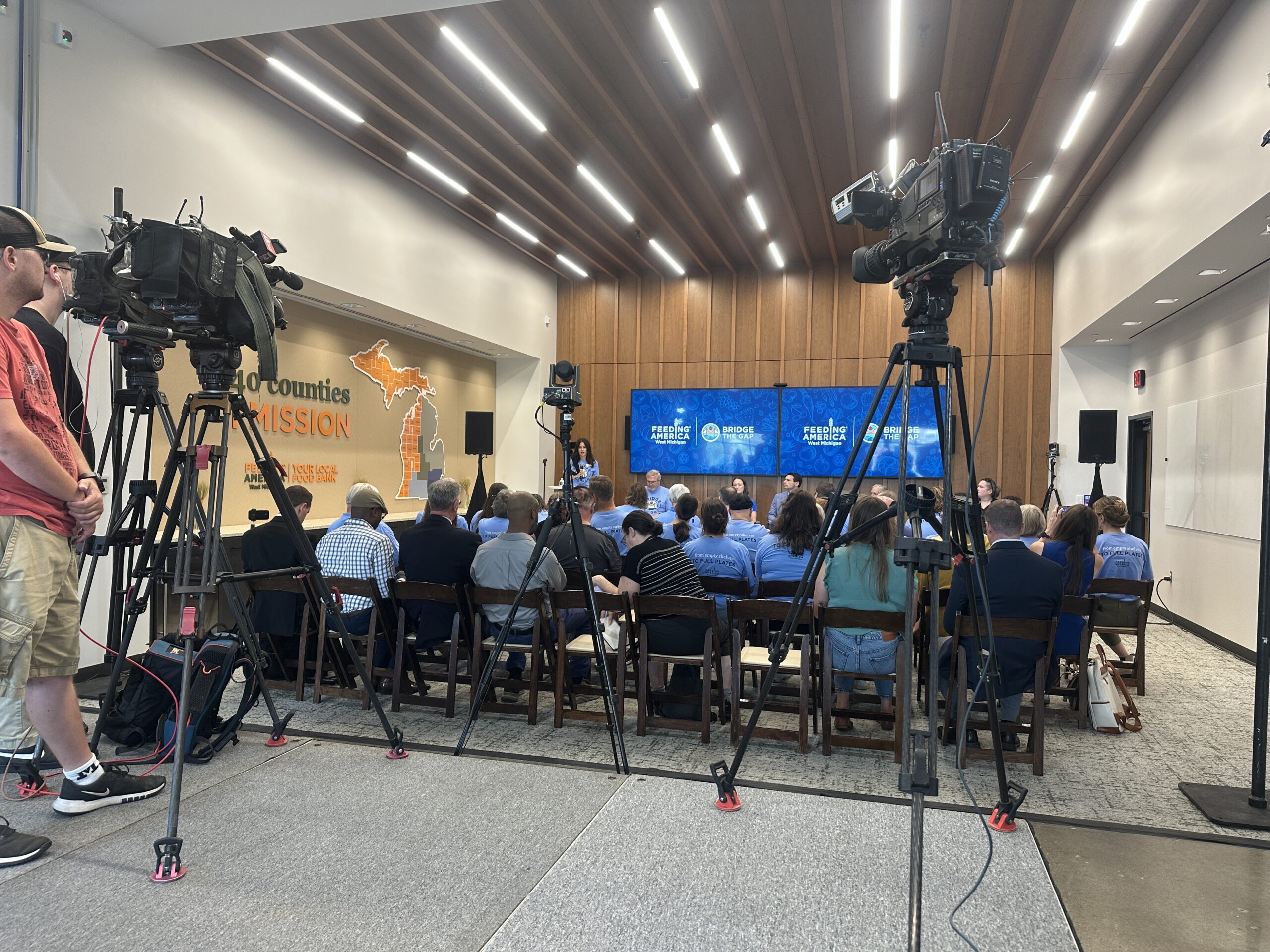 Members of the local media cover Feeding America West Michigan's Bridge the Gap fundraising campaign announcement.