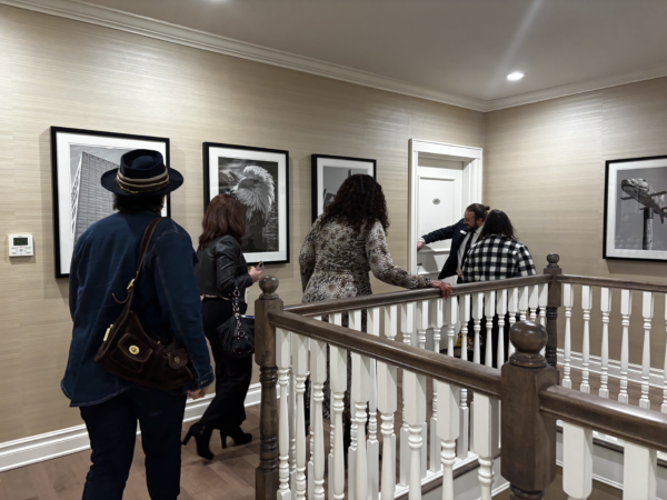 people walking around a staircase at the fisher house
