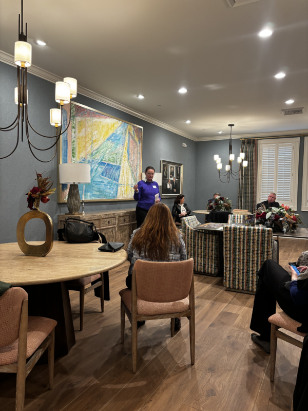 someone giving a speech to lawmakers at the fisher house