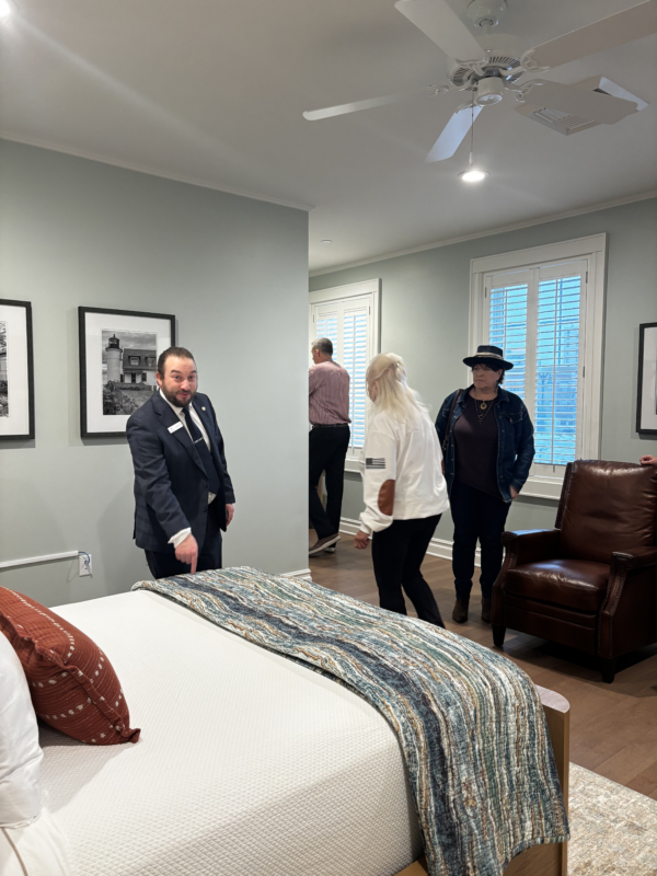 inside one of the rooms at the fisher house, people are getting a tour