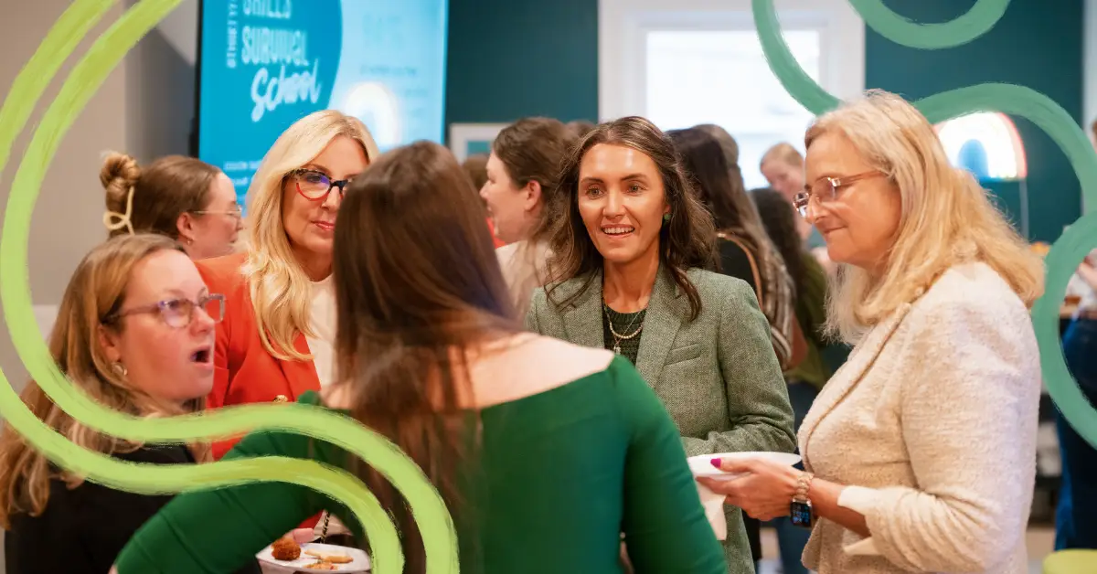 a group of women talking and smiling