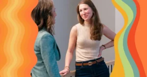 two women smiling and talking
