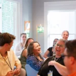 attendees of a luncheon laughing.