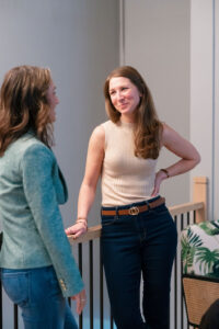 two women smiling and talking