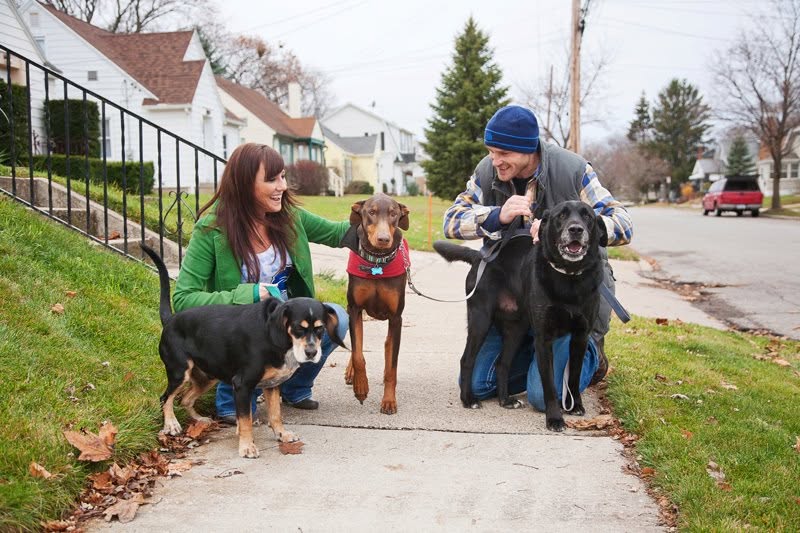 A couple walking their 3 dogs in the Creston neighborhood.