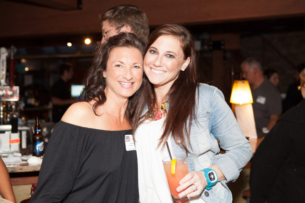 Two women smile at the camera